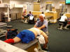 Volunteer athletic trainers Ted and John work on athletes inside of our sports med clinic.