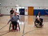 Serving in wheelchair volleyball.